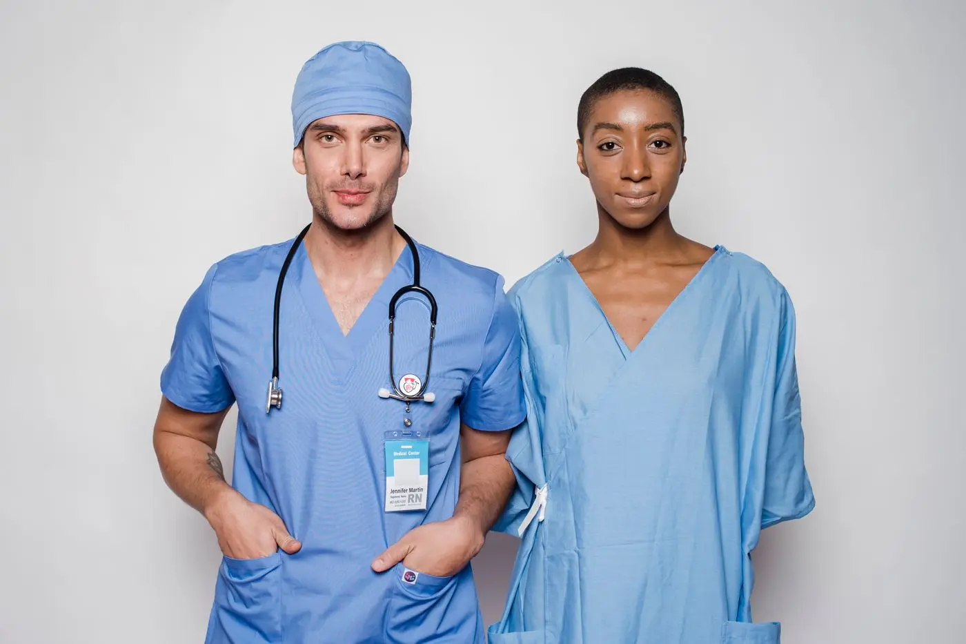 Two diverse healthcare professionals smiling together in a bright modern hospital
